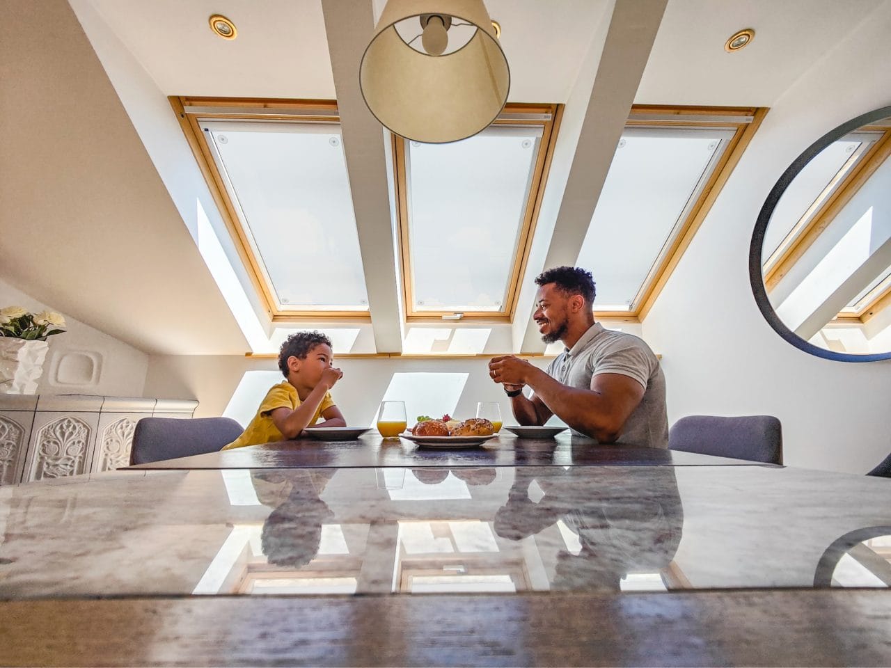 Father And Son Enjoying Breakfast In The Kitchen